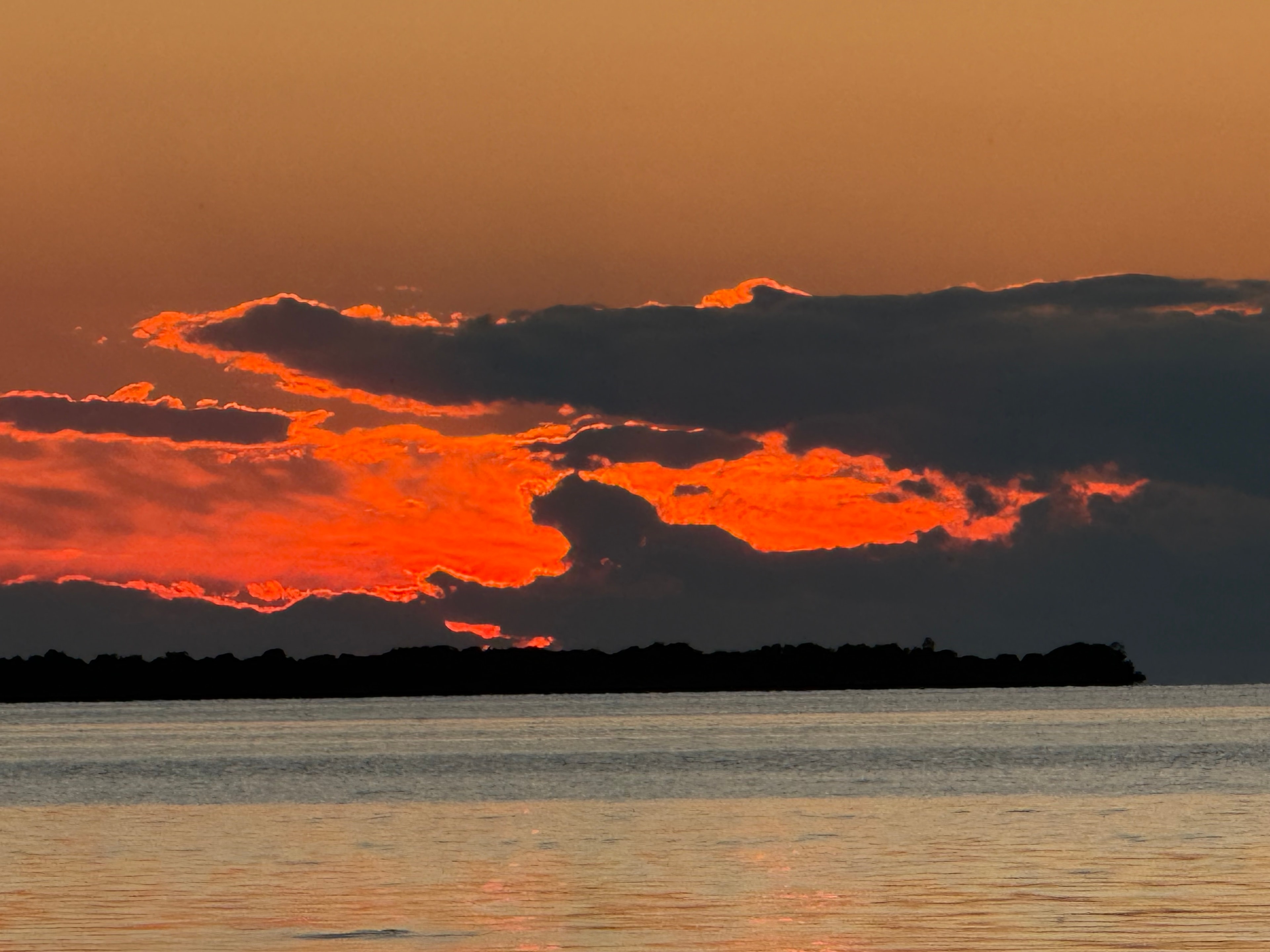 Fiery Sunset Clouds Over the Island