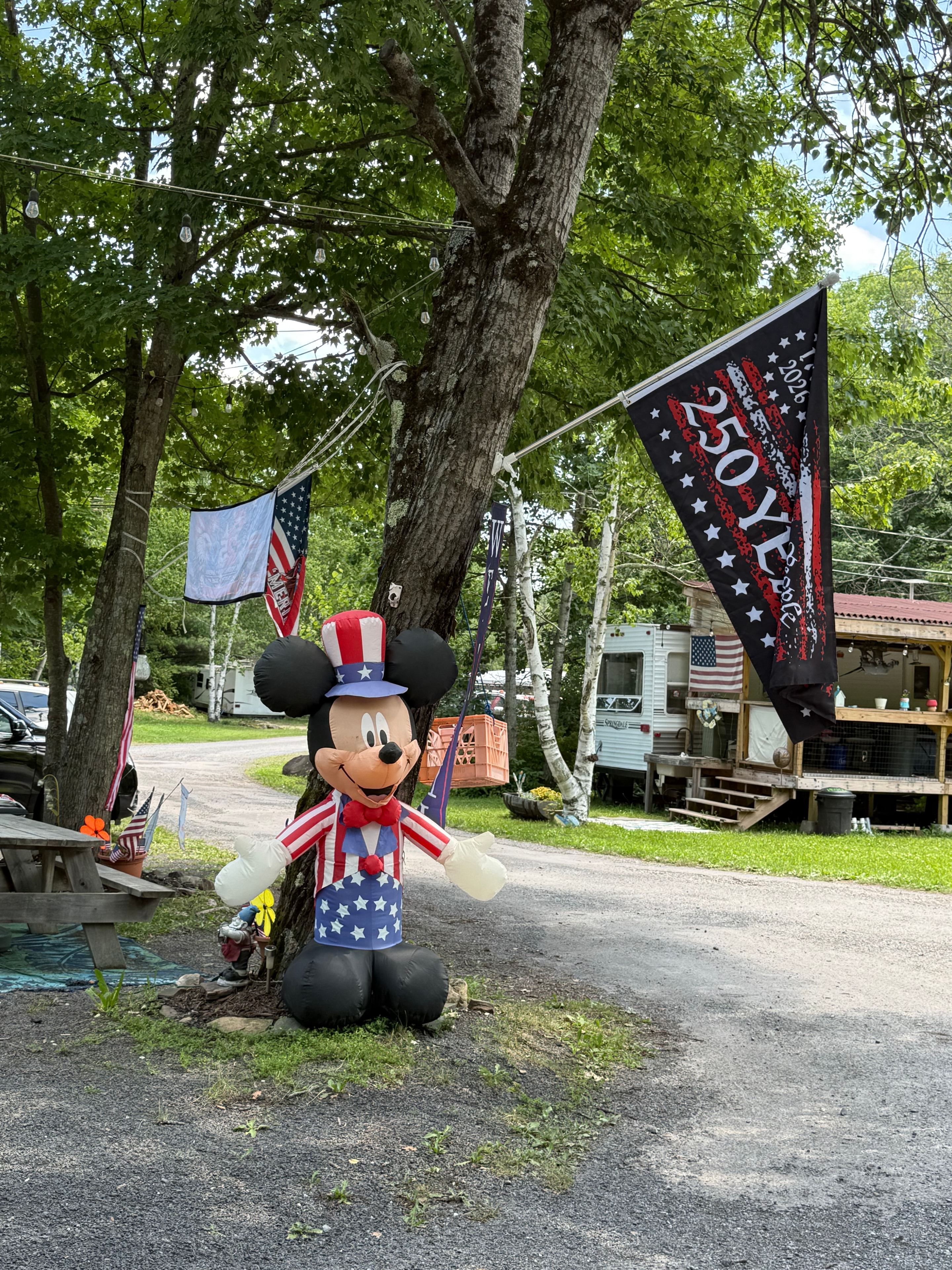 America 250 years — Mickey Mouse & flag at campground