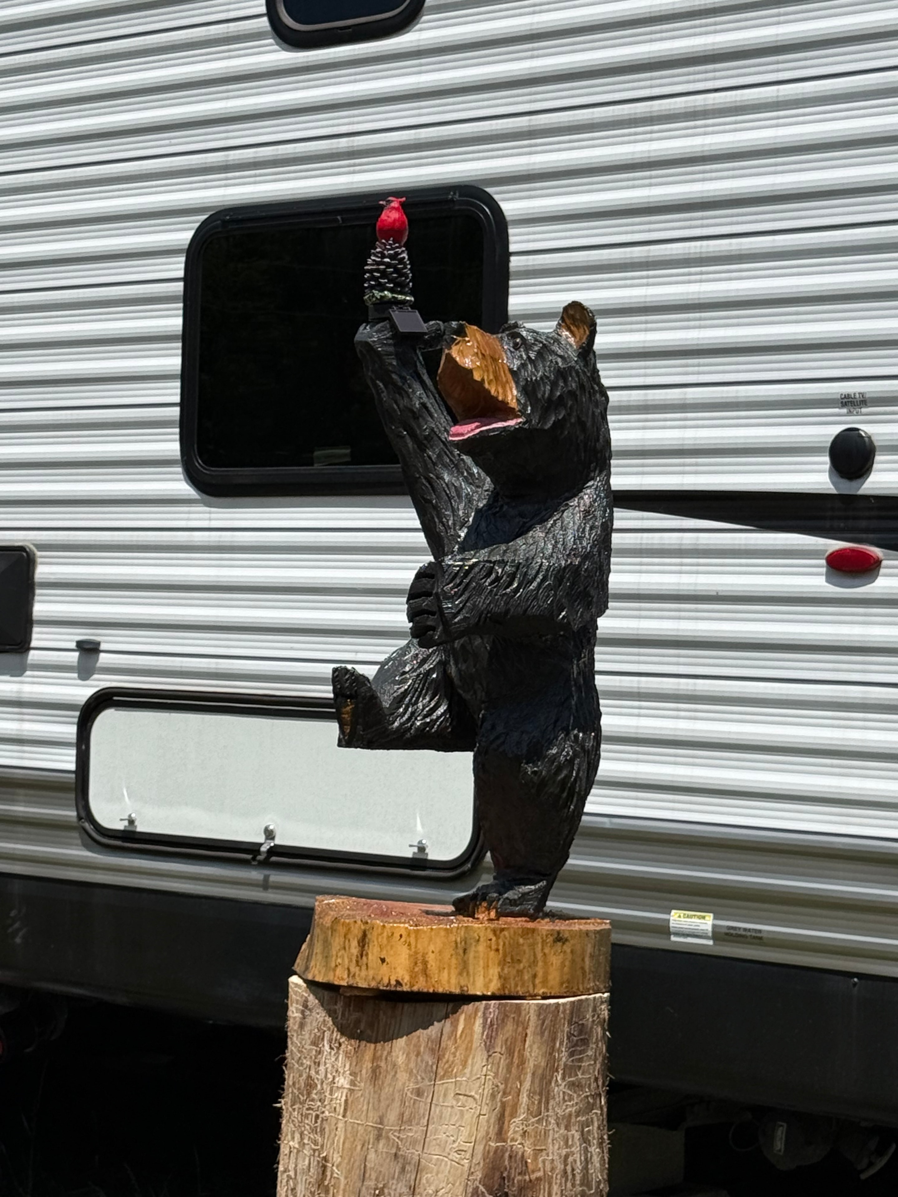Bear sculpture with red accent on RV