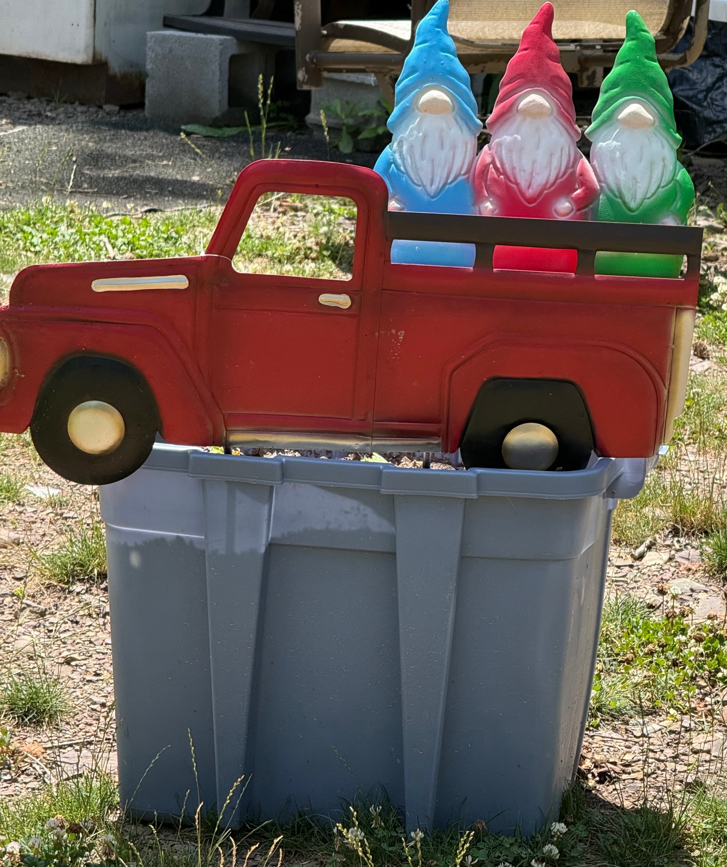 Gnomes in a red truck decoration
