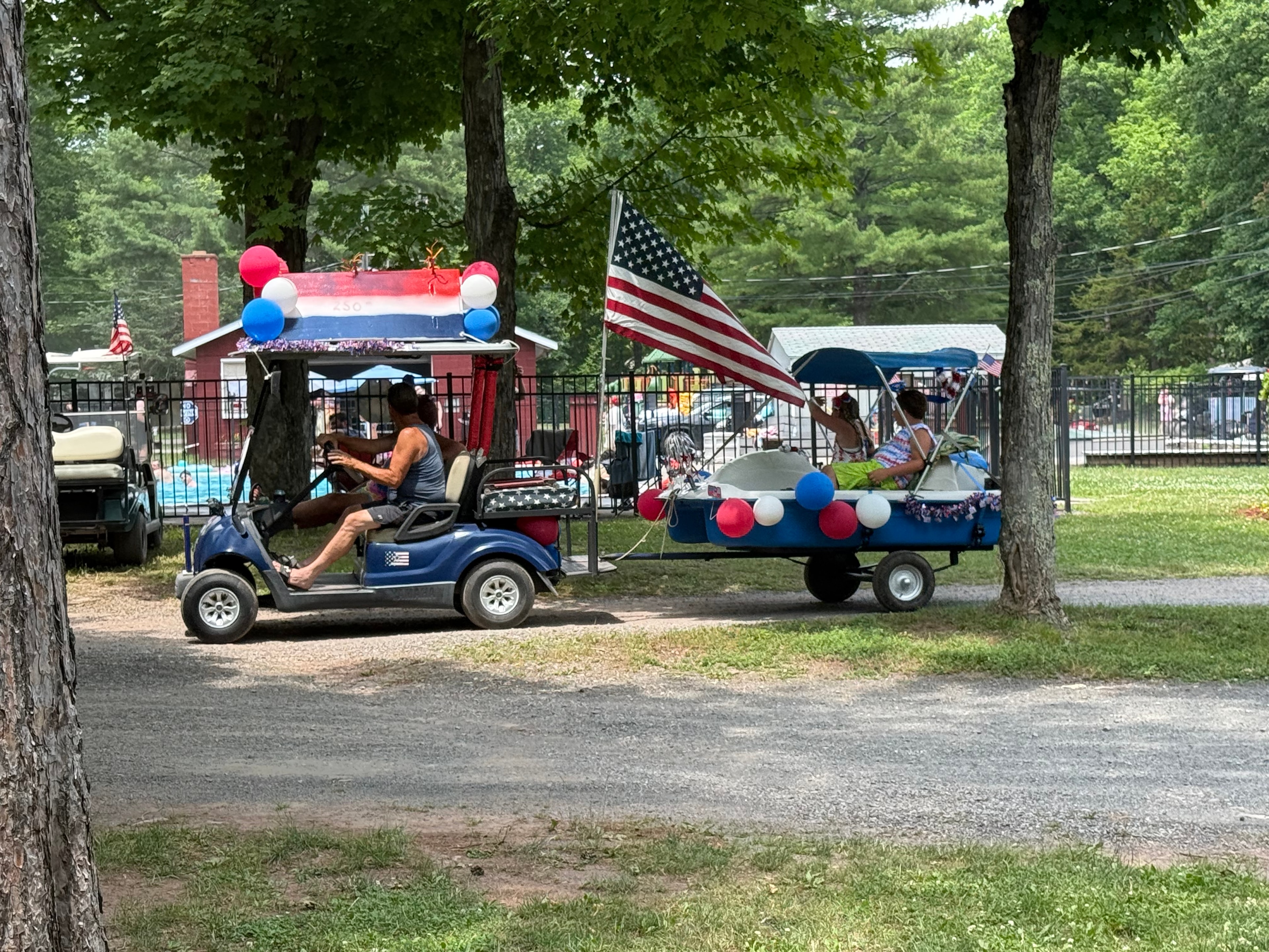 Blue cart pulling a decorated boat trailer