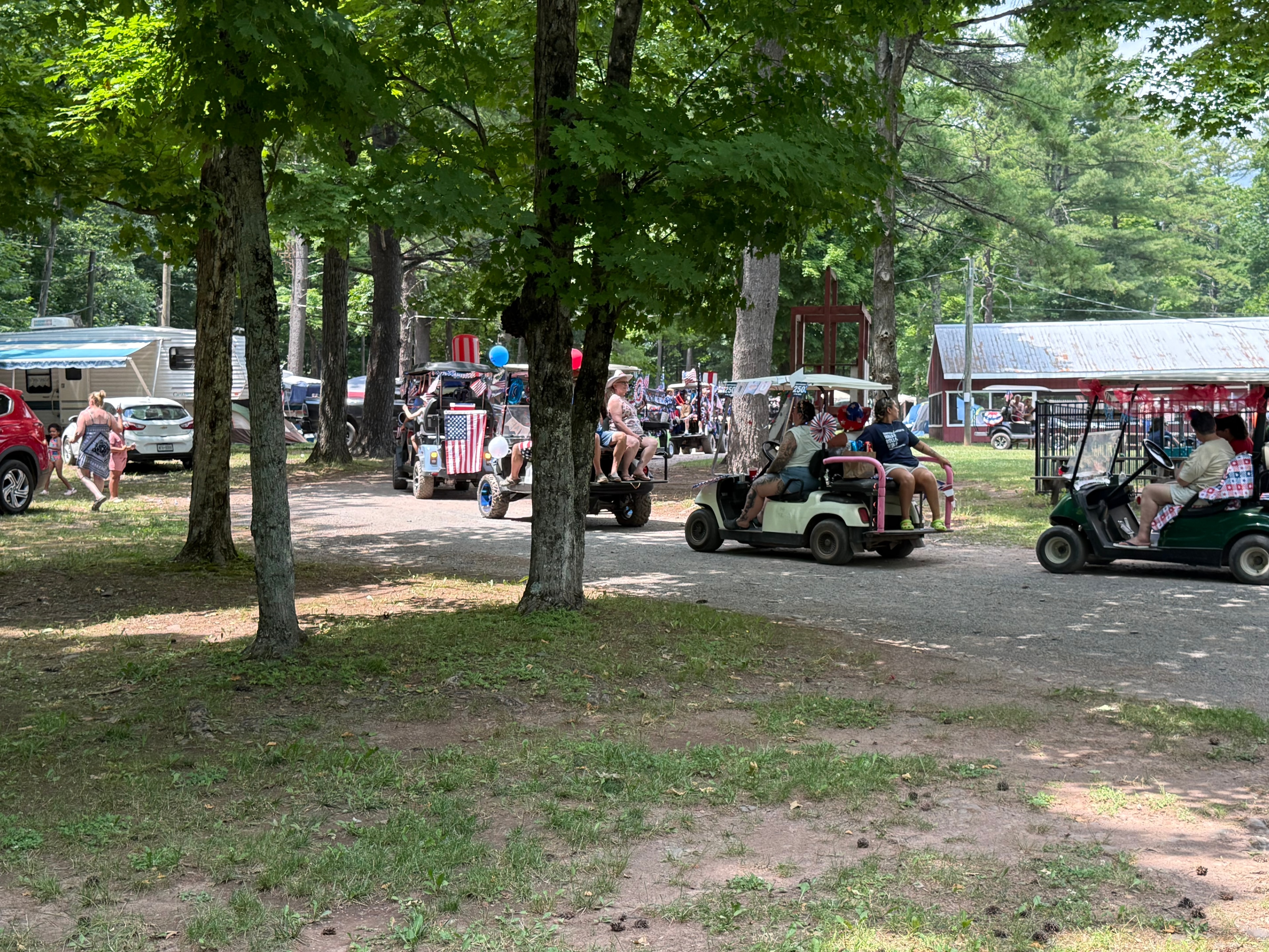 Parade of carts winding through the campground trees