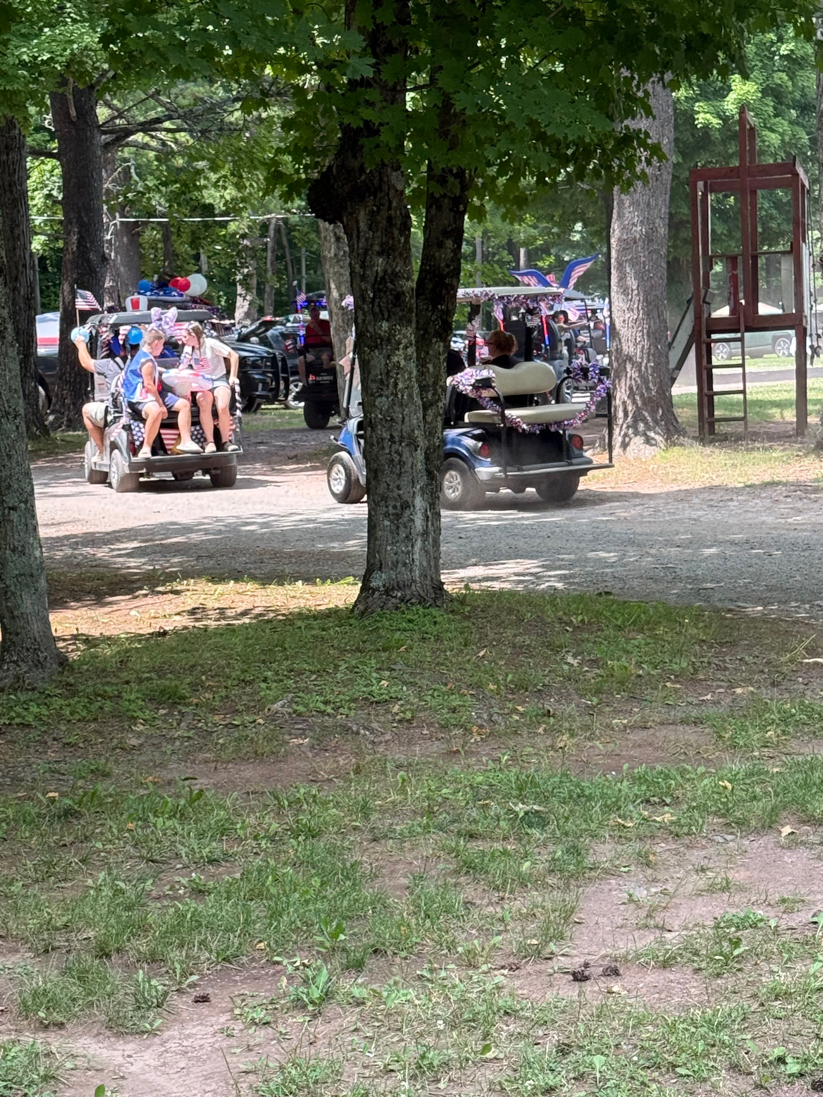 Parade carts winding through the trees