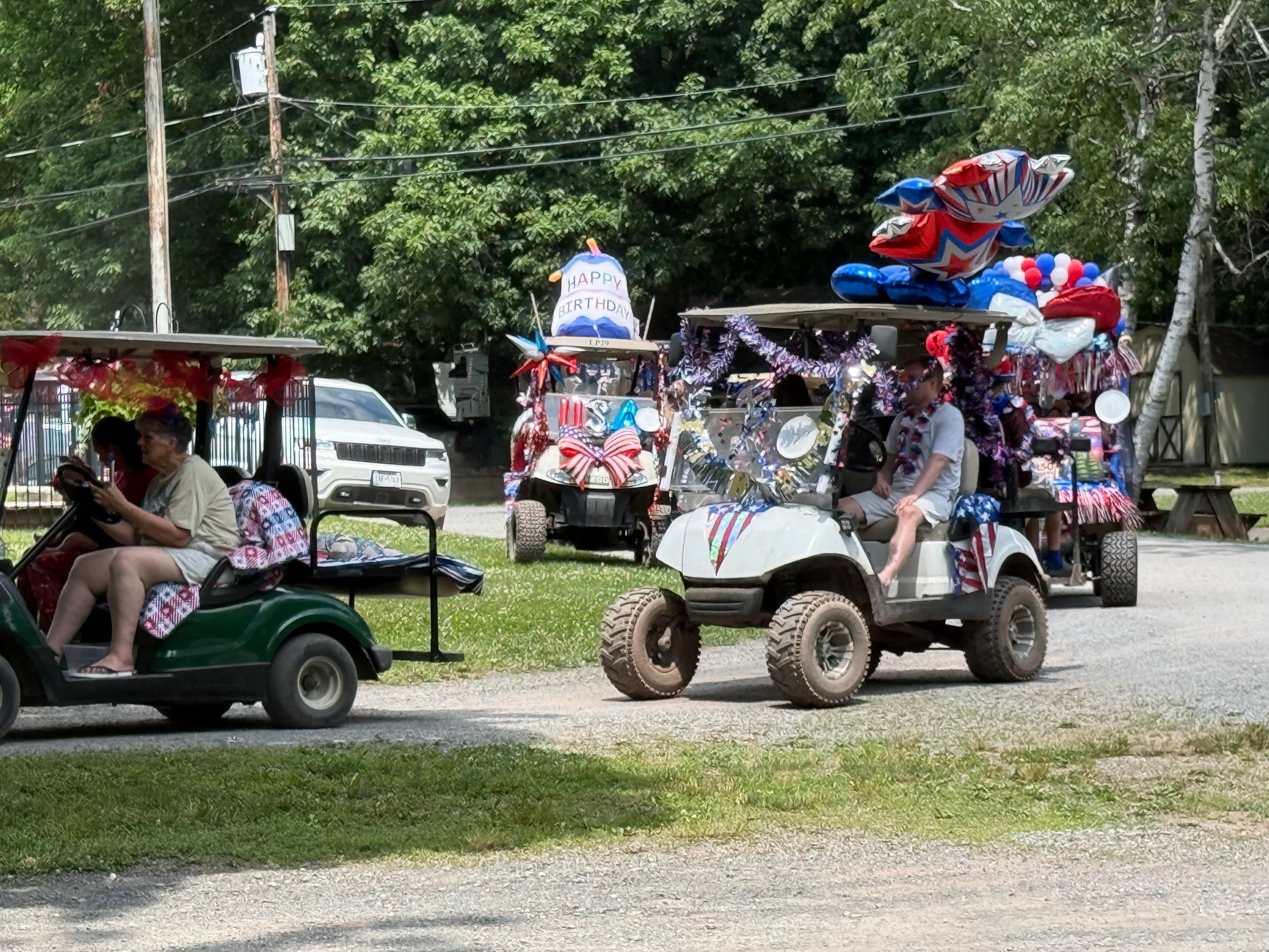 Green cart with birthday balloons and patriotic decorations