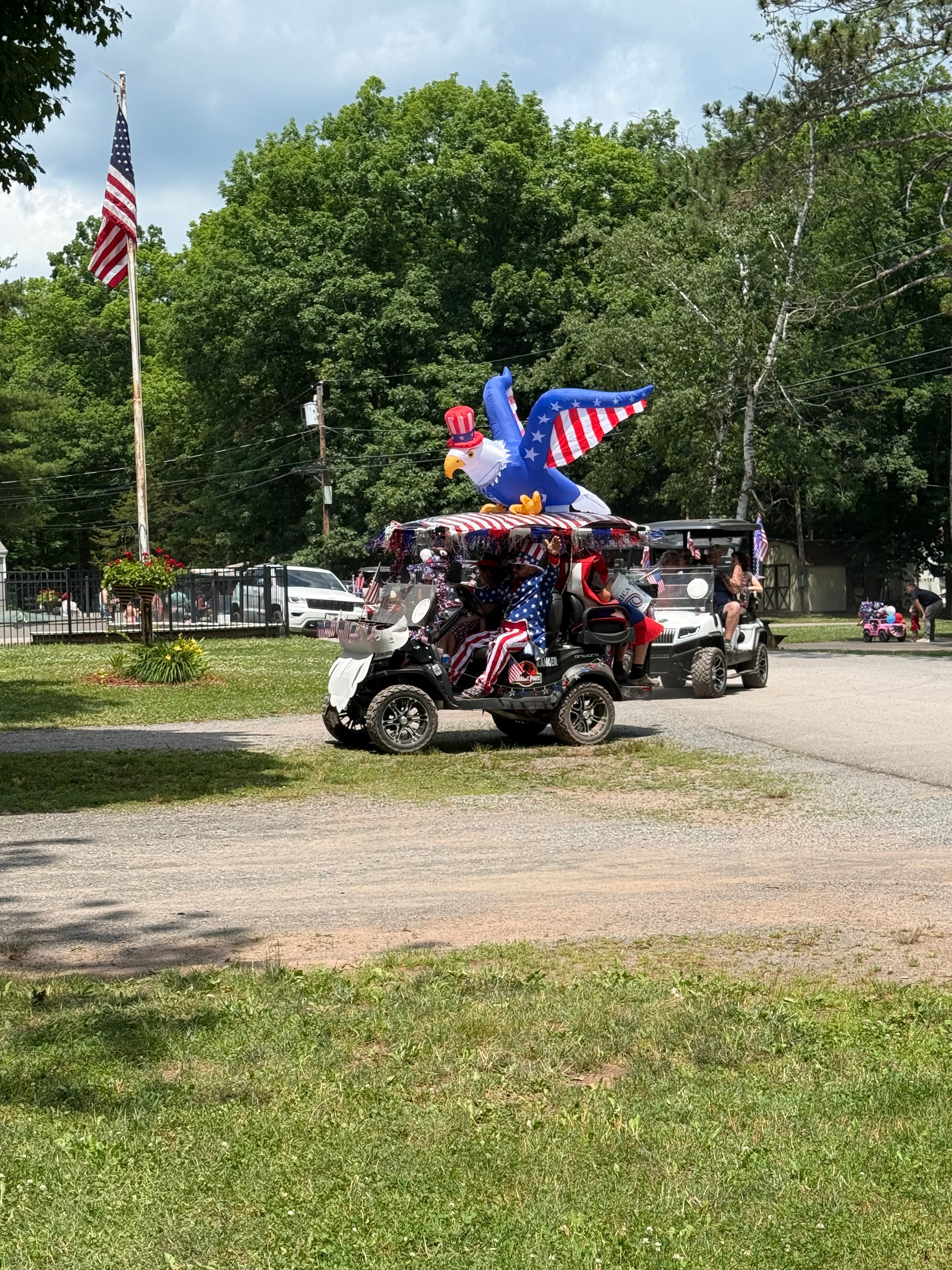 Inflatable eagle on a decorated golf cart