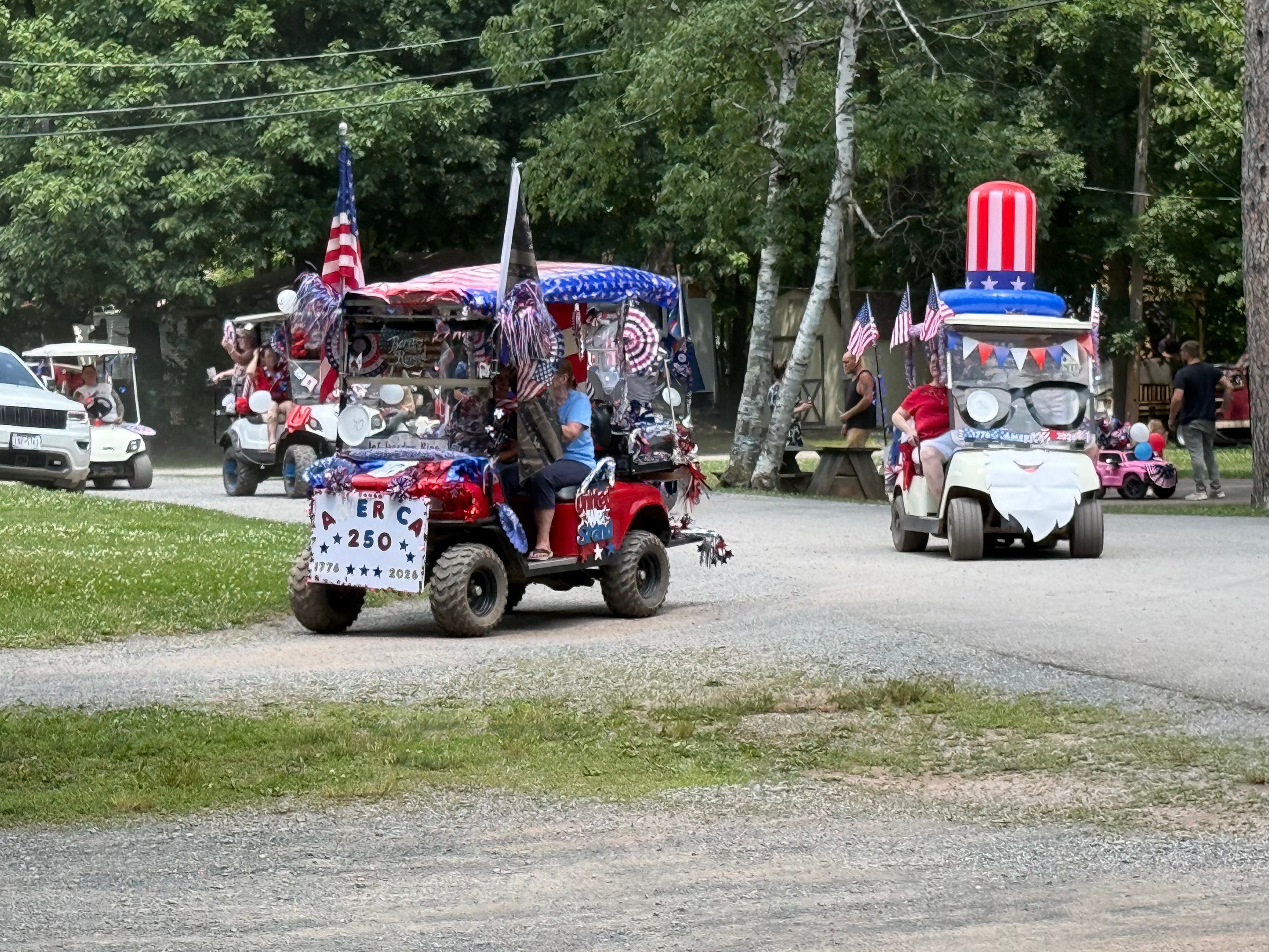 Red cart with America 250 sign and Uncle Sam inflatable
