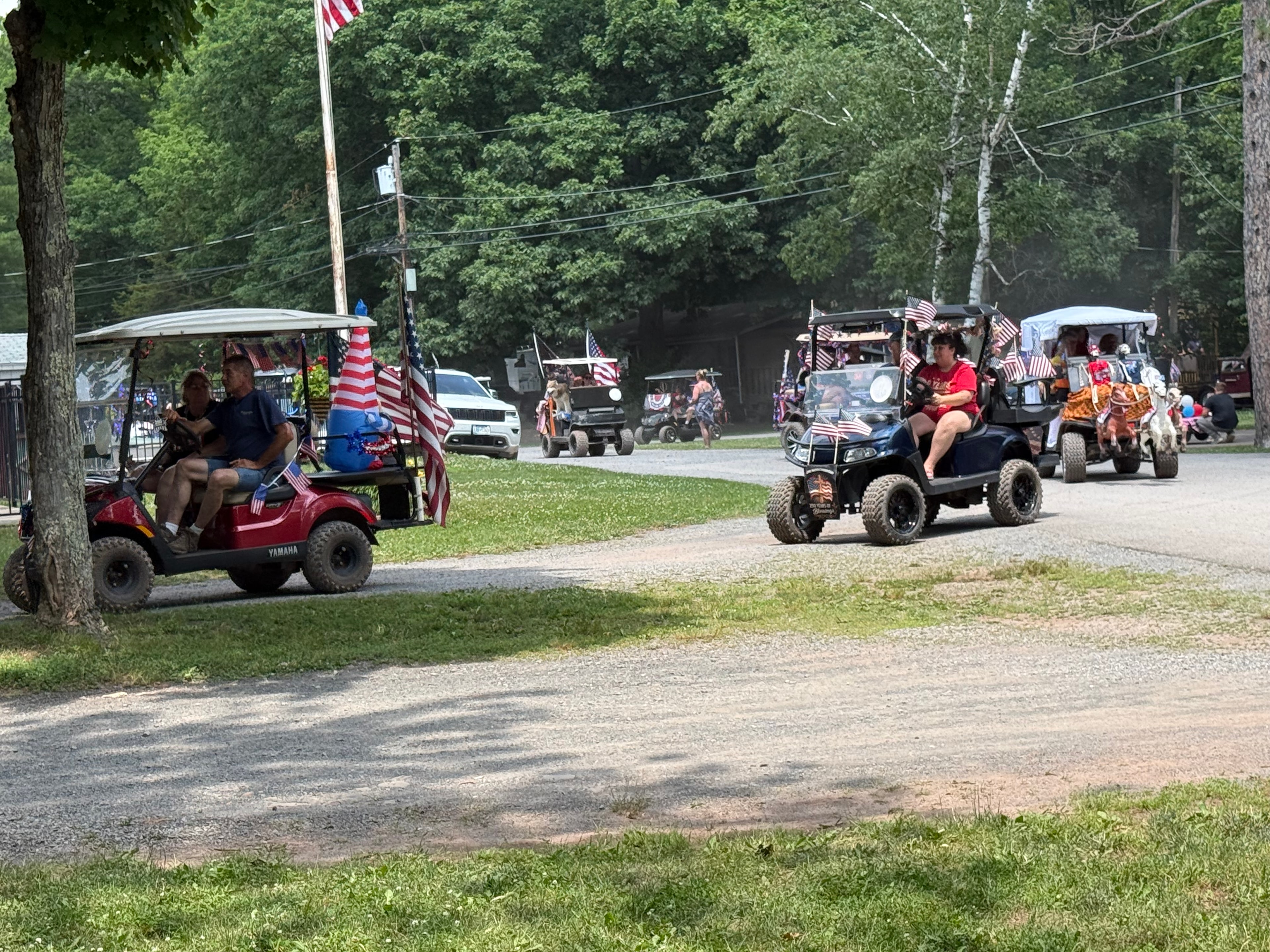 Yamaha & black carts rolling through the campground parade