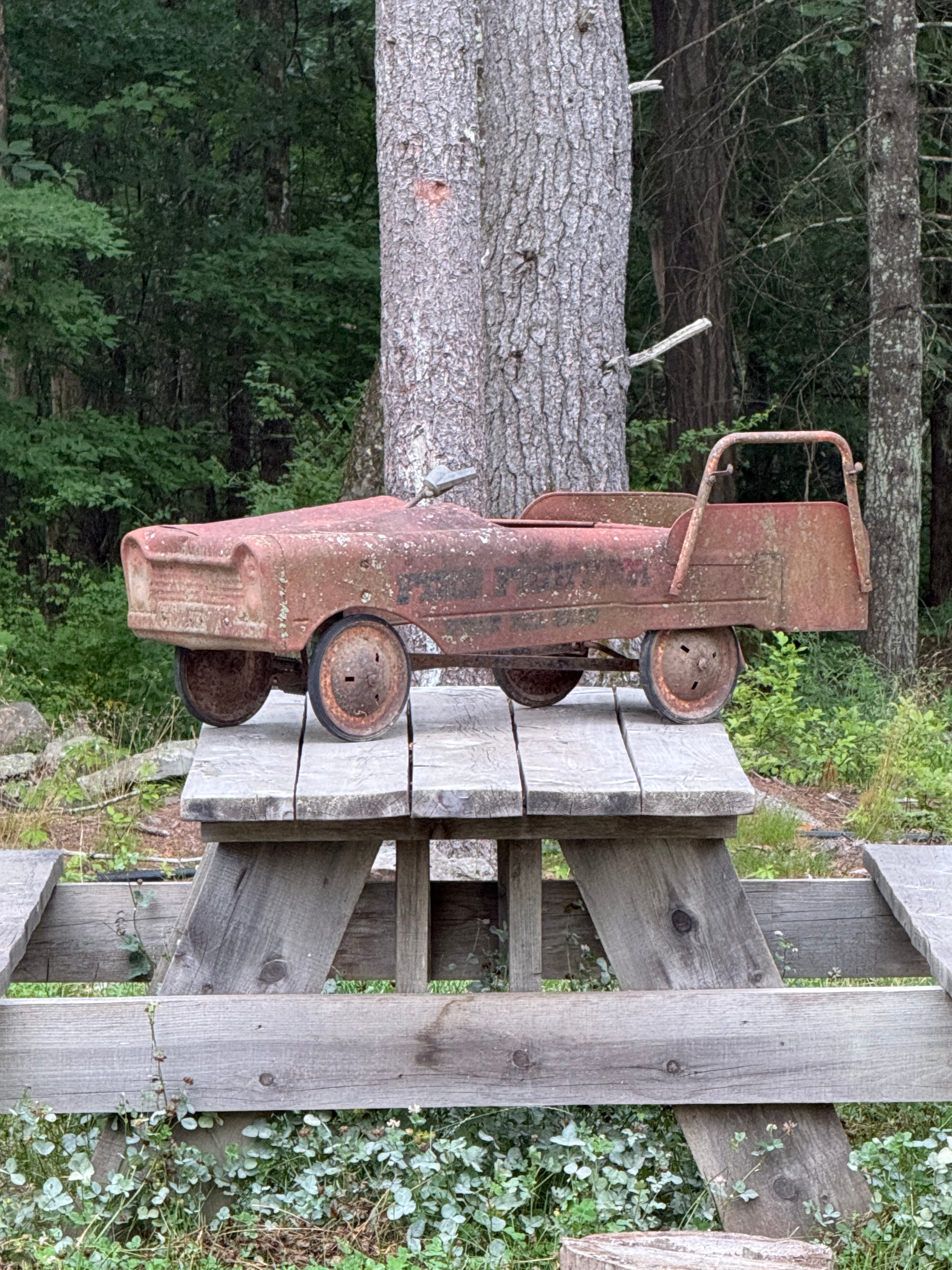 Rusty antique toy truck on the fence