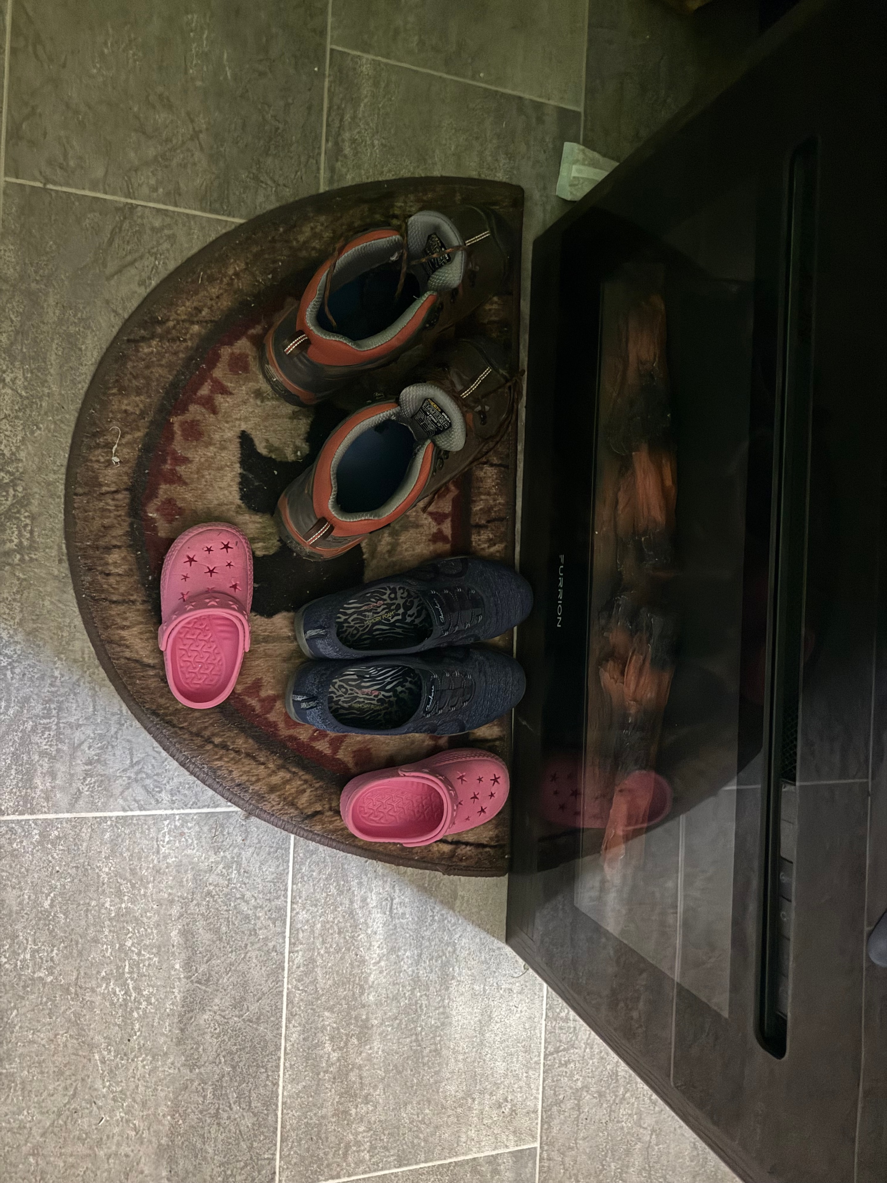 Shoes at the door — Furrion fireplace glowing