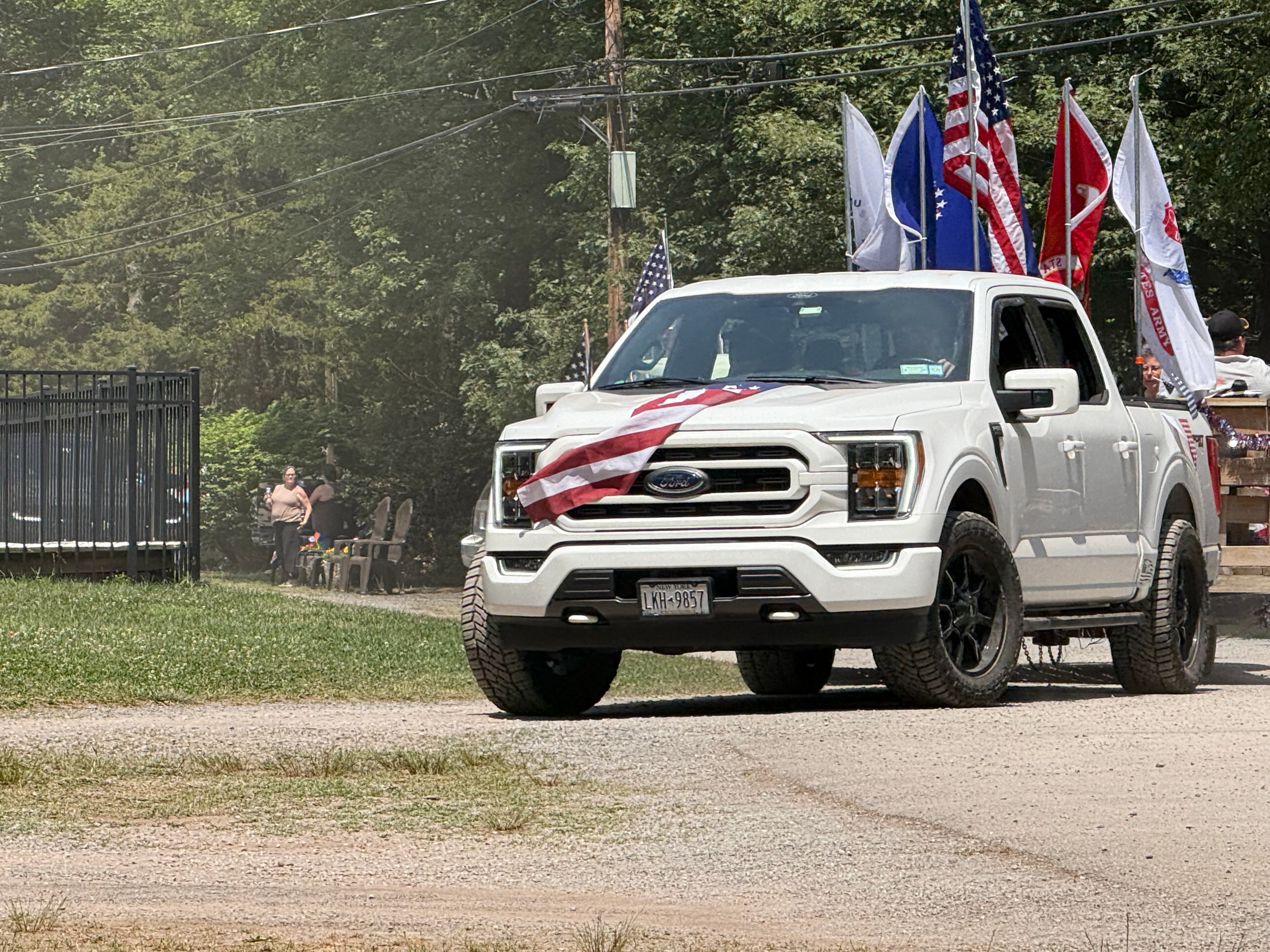 Ford F-150 flying flags down the road
