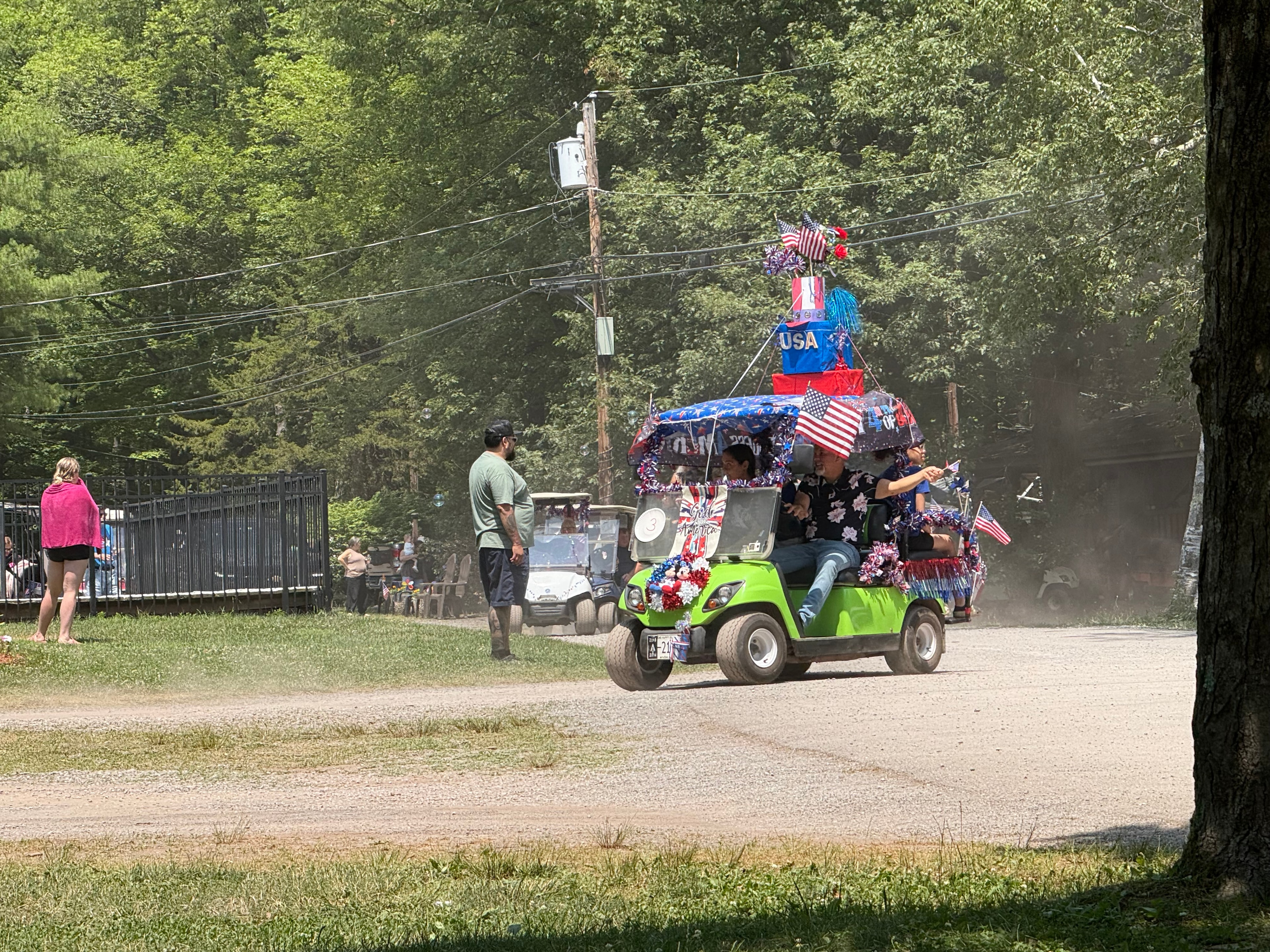 Green golf cart decorated for the parade