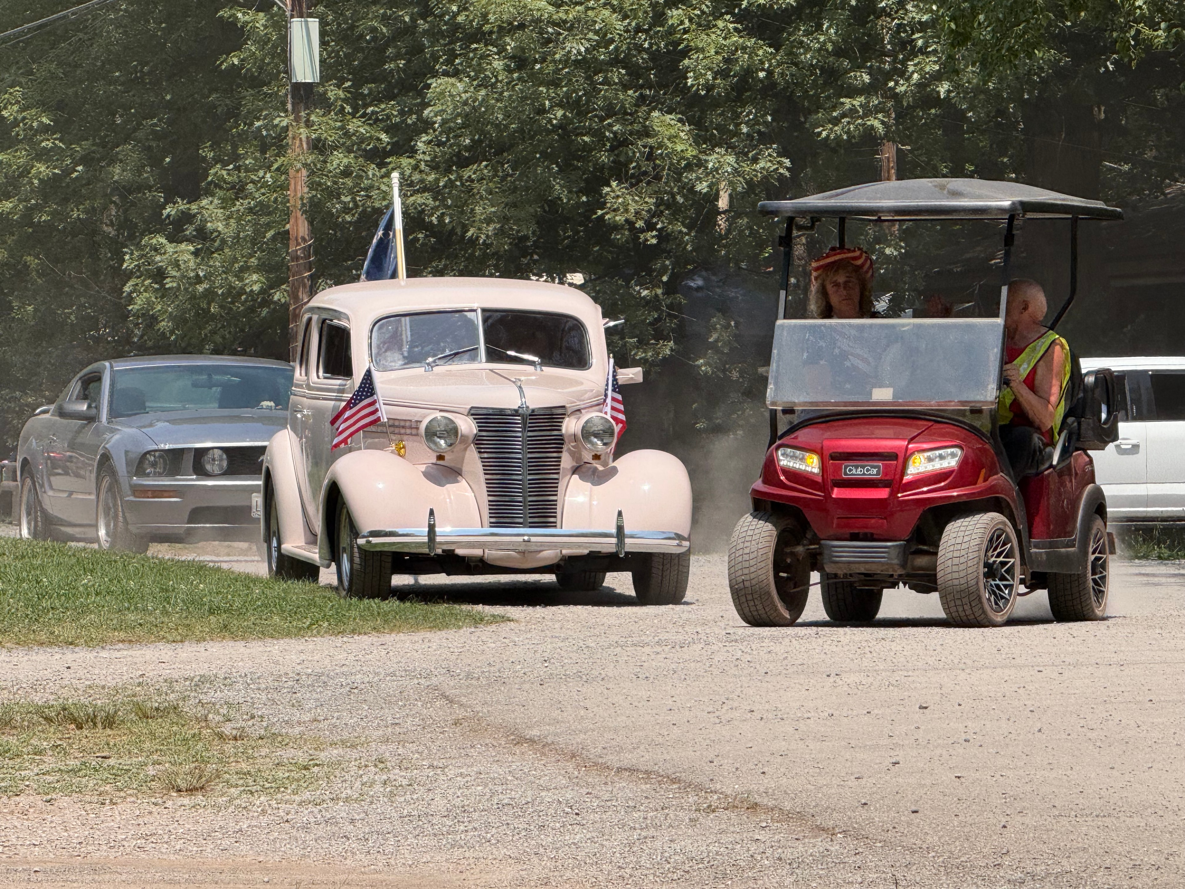 Vintage car and Mustang in the parade