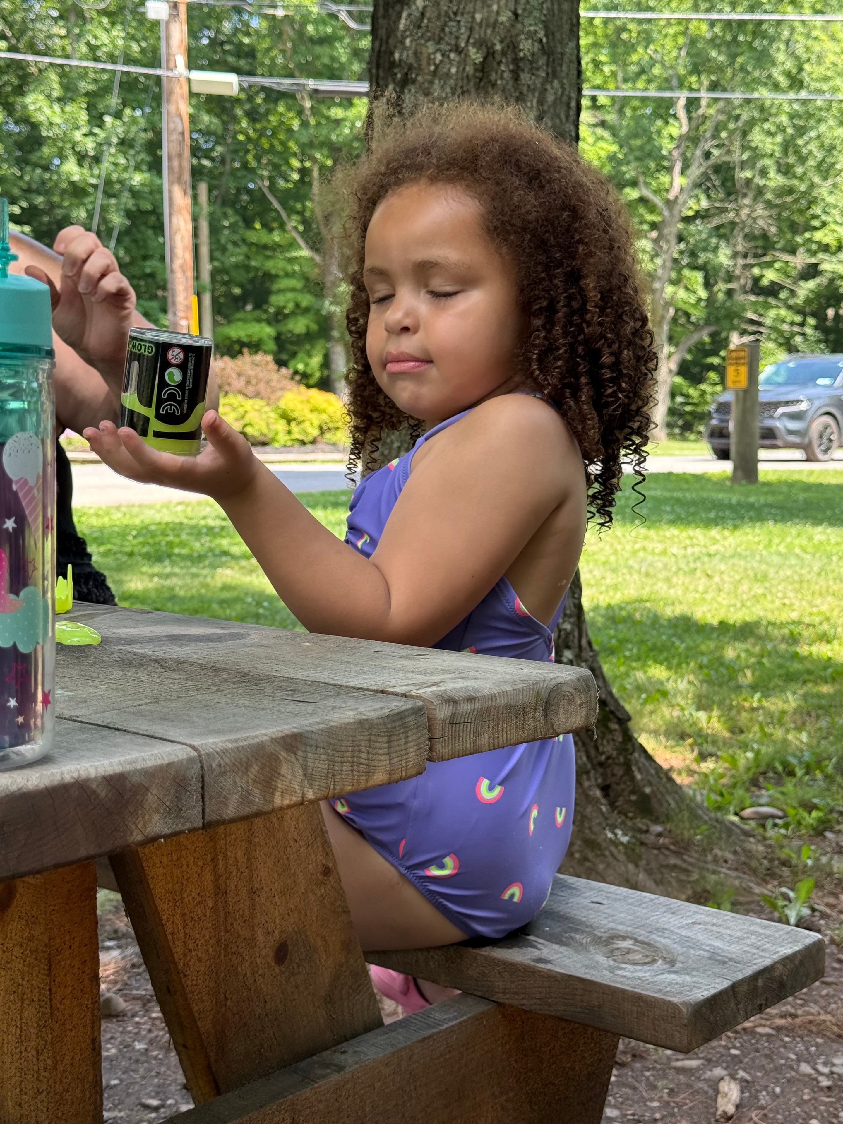 Playing with a glow stick at the picnic table