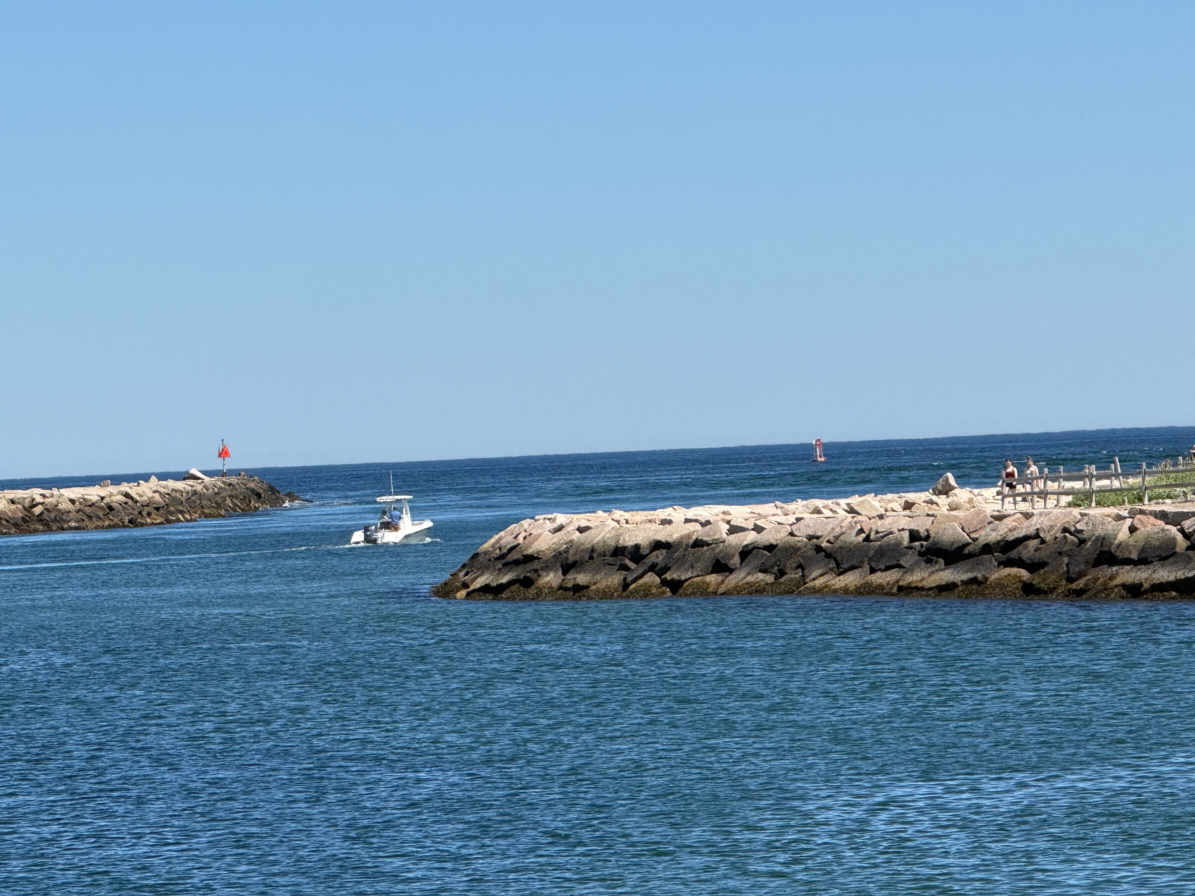 Boat navigating the rocky jetty
