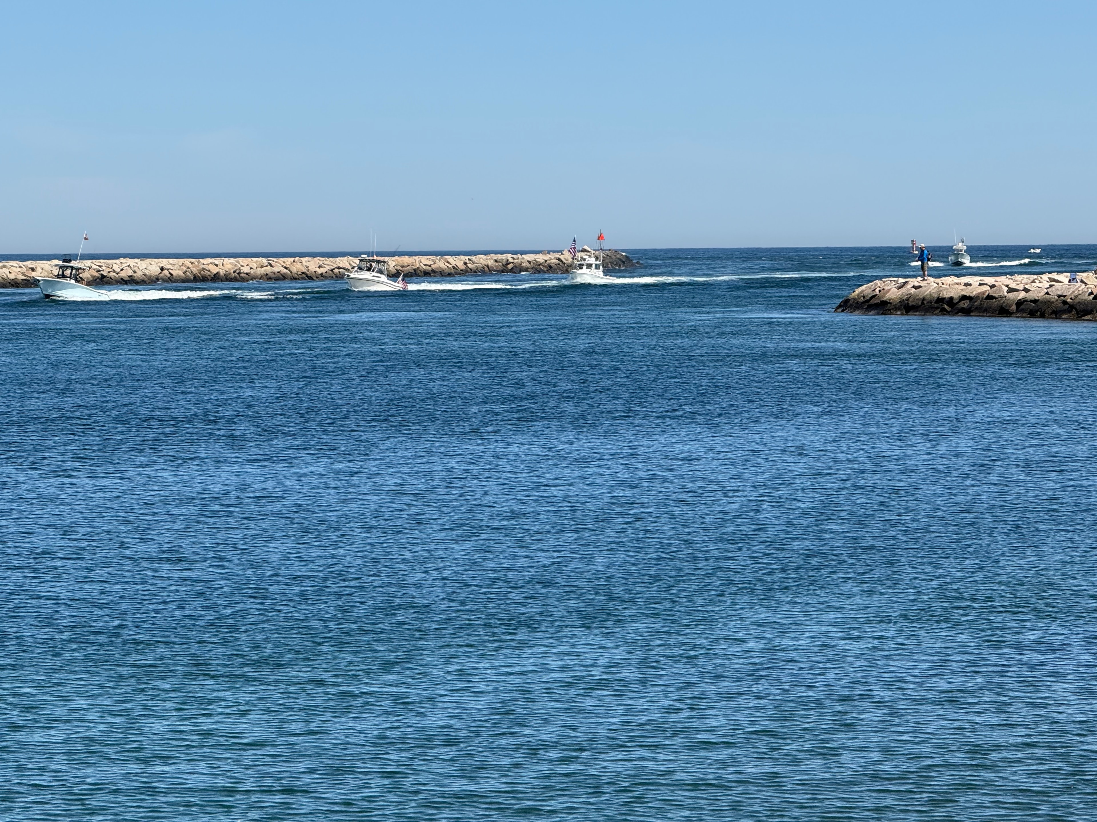 Boats passing the breakwater