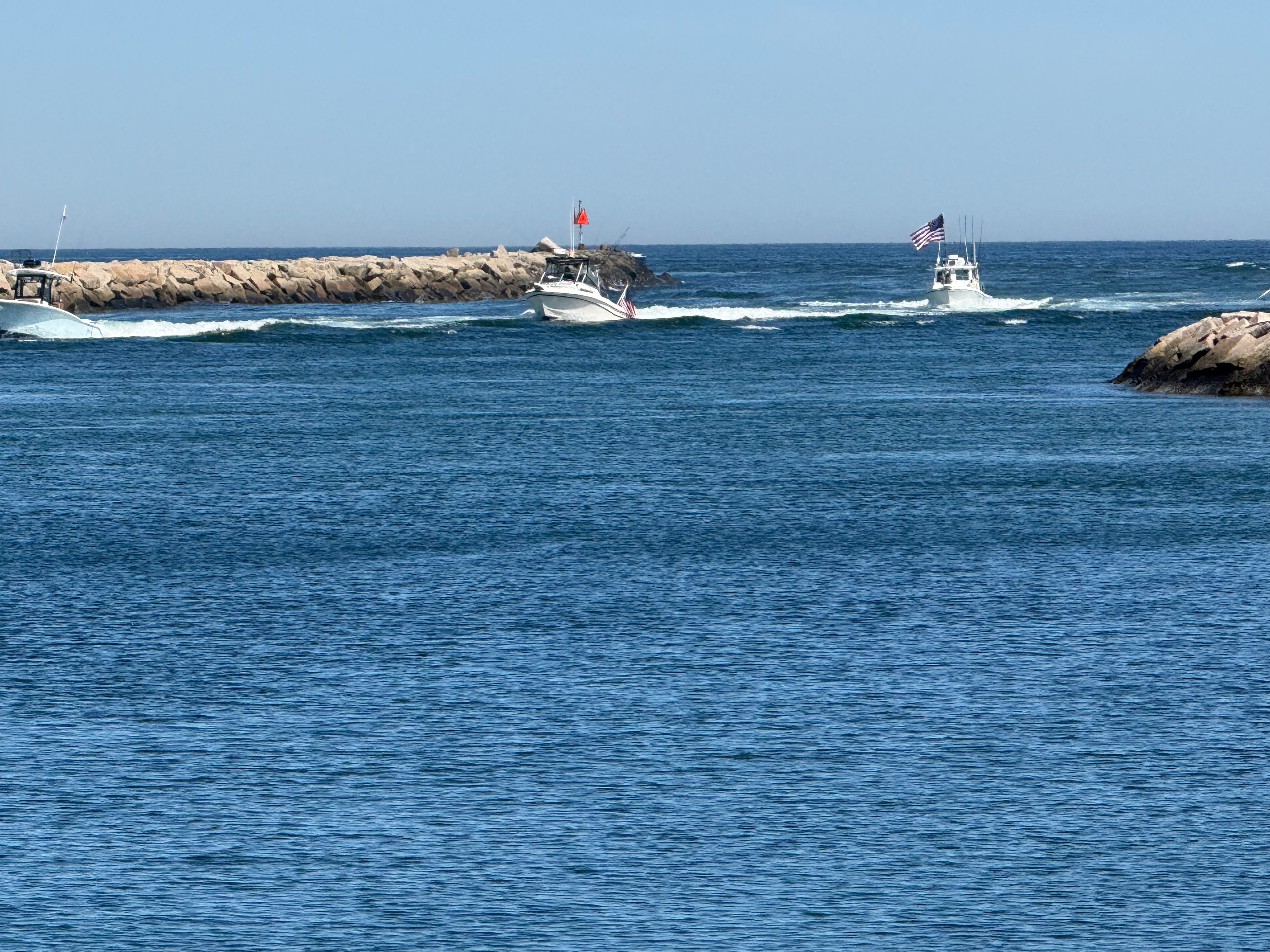 Boats heading to harbor from the sea