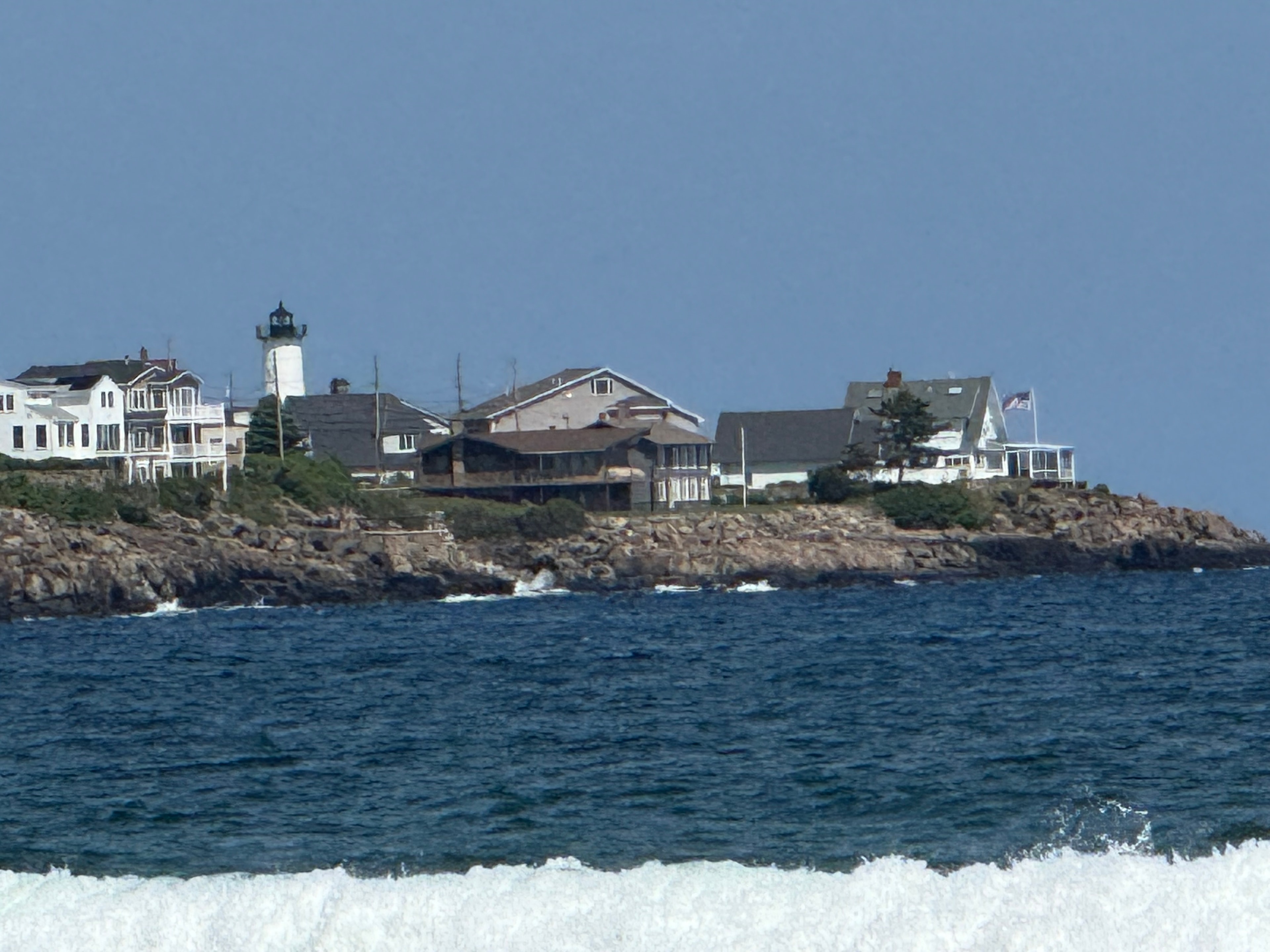 Lighthouse on a rocky island seen from the water