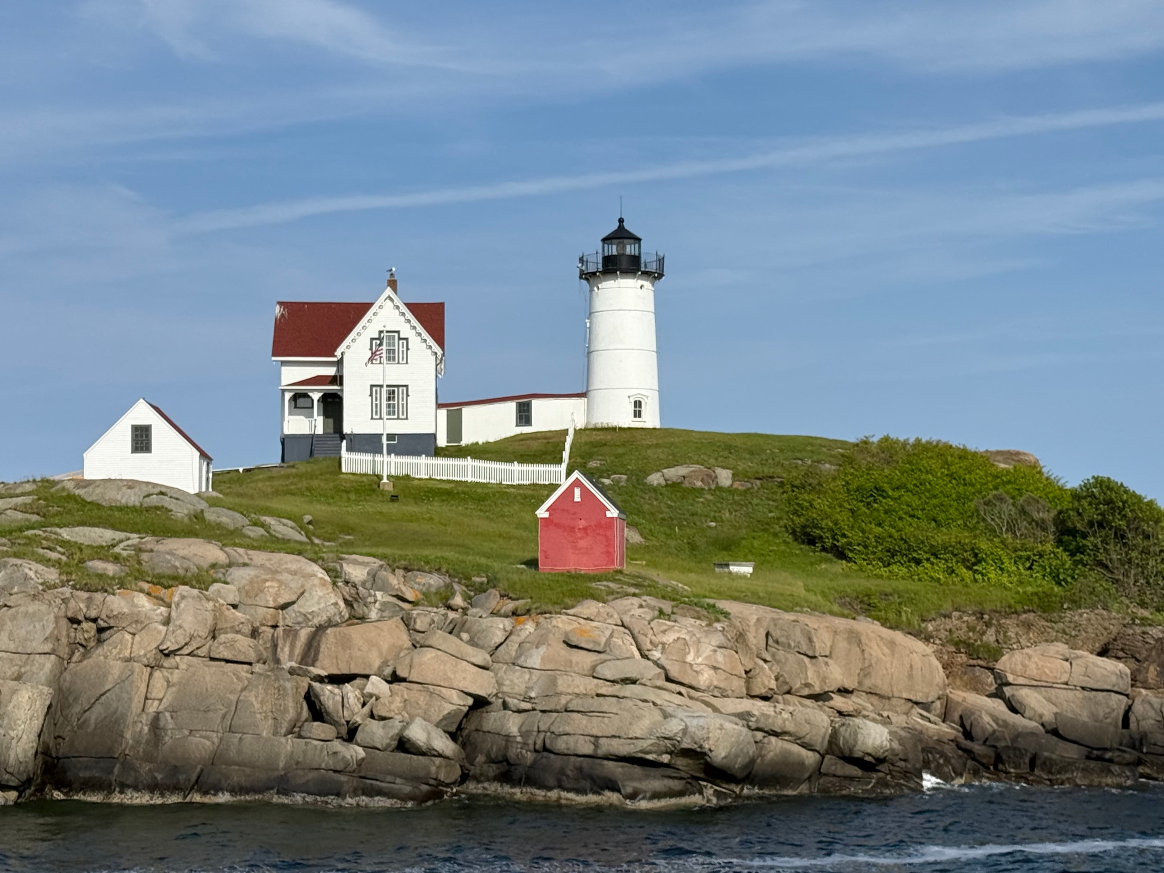 Nubble Lighthouse with red shed on the rocky island